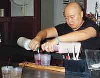 Arthur double pours during bartending mixology class